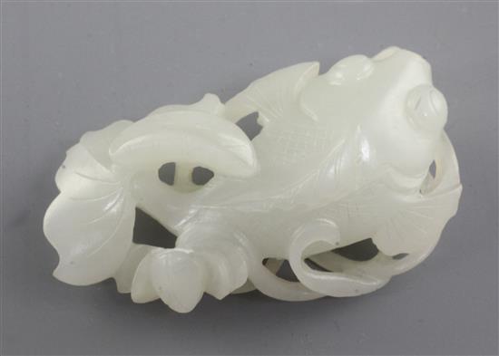 A Chinese white jade carving of a goldfish amid lotus, late 19th / early 20th century, 6.4cm
